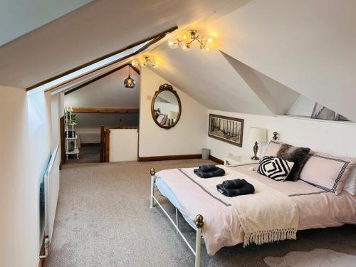 a bedroom with a large bed in a attic at A beautiful Large 7 bed house in Porthcawl