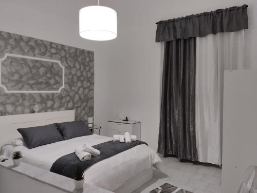 a bedroom with a bed with two stuffed animals on it at House Lurokè in Catania