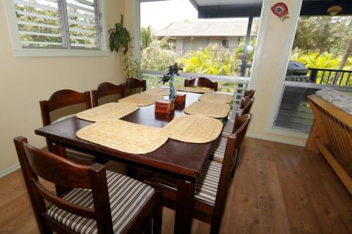 a dining room with a table with chairs and a tableablish at All Inclusive Waimanalo Beachlots, Sleeps 8 in Waimanalo