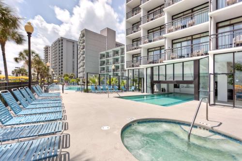 an image of an apartment complex with a swimming pool at Dayton House Resort - BW Signature Collection in Myrtle Beach