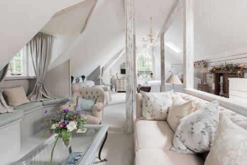 a living room with a white couch and a table at Magical and Romantic Countryside Getaway Near Windsor Castle in Old Windsor