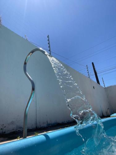 a water fountain in a swimming pool at Casa Oceano in Marechal Deodoro