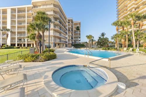 a swimming pool with chairs and a building at Shipps Landing #518 in Marco Island
