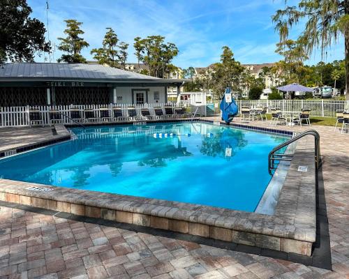 a swimming pool with blue water at 15 min to Disney World, Self-check-in, Full Kitchen in Kissimmee