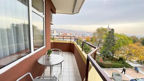 a balcony with a table and a view of the city at Dezudava Family Hotel in Sandanski