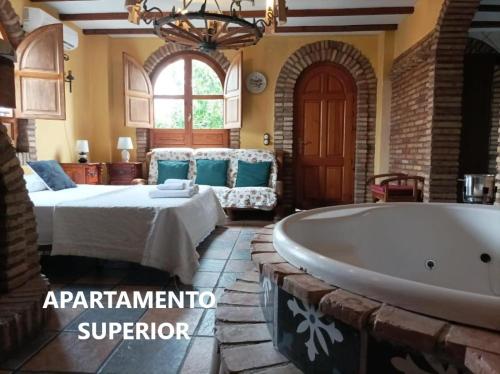 a bedroom with a bed and a bath tub at Alojamientos La Casa de Piedra in Murcia