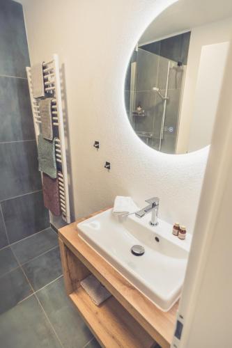 a bathroom with a sink and a mirror at Anna Pertl - lieblingsquartier in Sankt Gilgen