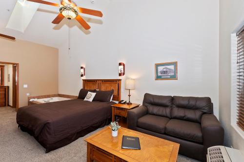 a living room with a bed and a couch at Robinhood Resort in Big Bear Lake