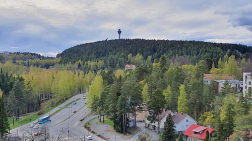 a hill with a water tower on top of it at Studio 12 floor, Puijo landscape, Free parking in Kuopio