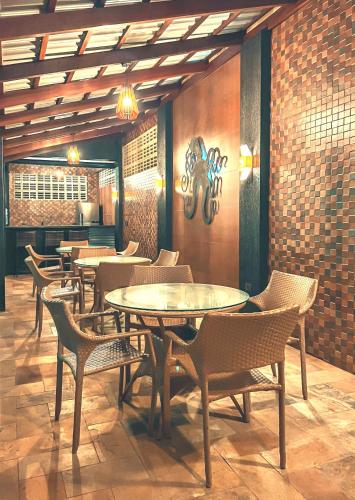 a restaurant with tables and chairs in a room at Mar e Lar in Maragogi