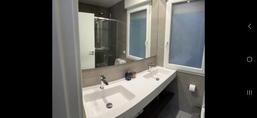 a bathroom with a white sink and a mirror at Salamanca Views in Madrid