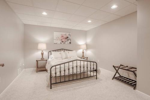 een slaapkamer met een bed in een witte kamer bij Family Friendly 5B Close to Trails, I-71, Mason with EV Level 2 Charging in Loveland