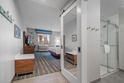 a bathroom with a shower and a bedroom at Hampton Inn Morro Bay in Morro Bay