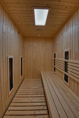 a wooden corridor with a skylight in a building at Cardoner Hotel és Konferenciaközpont in Dobogoko