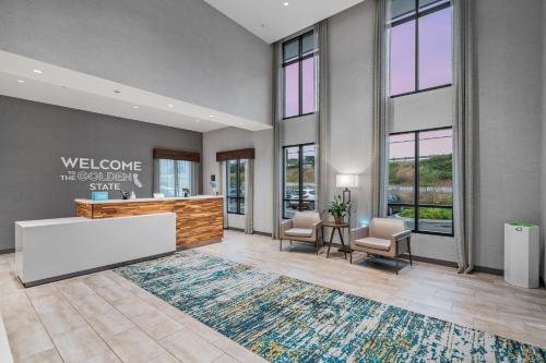 an office lobby with a reception desk and chairs at Hampton Inn Morro Bay in Morro Bay