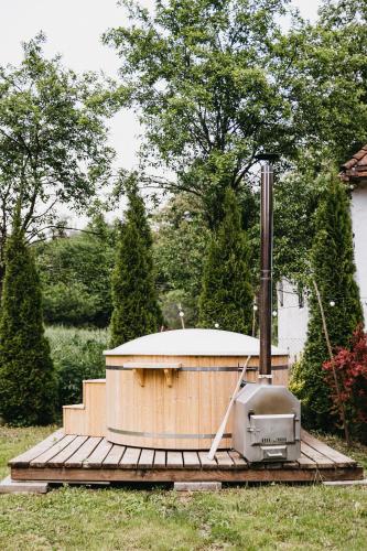 a hot tub sitting on top of a wooden deck at Lazar Guesthouse in Şiclod