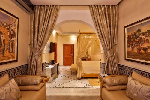 a living room with a couch and a bedroom at Palais Amador in Oulad Mazoug