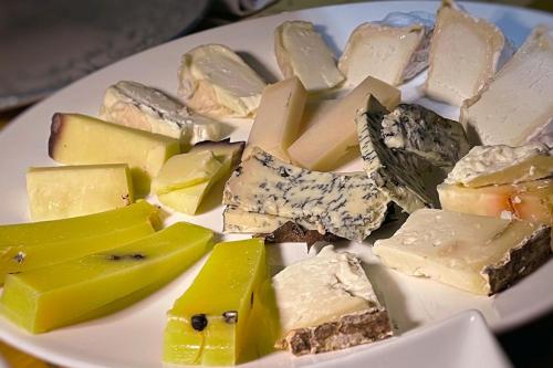 a white plate with different types of cheese on it at LOCANDA LE 4 CIACOLE in Roverchiara