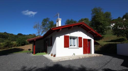 a small chapel with red doors and a white steeple at Ene chocoa in Louhossoa