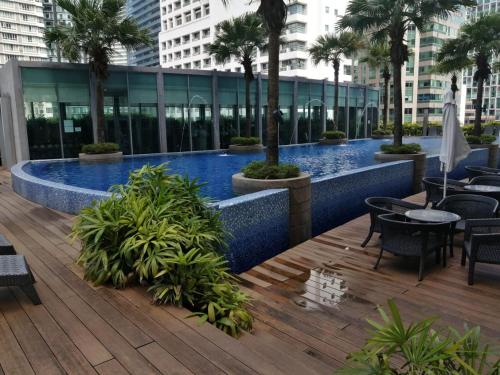 a swimming pool on the roof of a building at Vortex Suites KLCC By Neptune in Kuala Lumpur