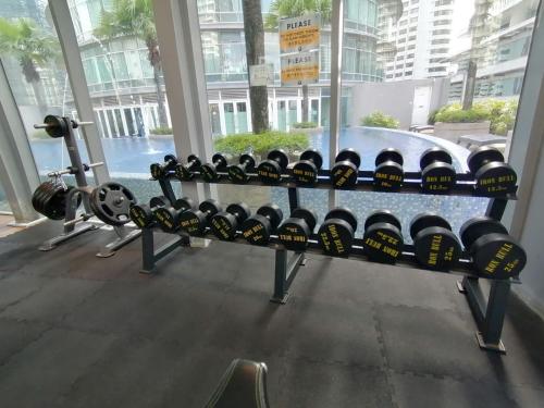 a bunch of wine bottles on a bench in a gym at Vortex Suites KLCC By Neptune in Kuala Lumpur