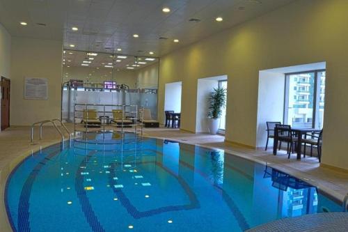 a large swimming pool in a hotel room at Life Above Clouds in Dubai