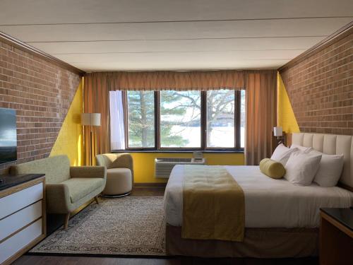 a hotel room with a bed and a television at The Lodge Luxury Resort At Lake Harmony in Lake Harmony