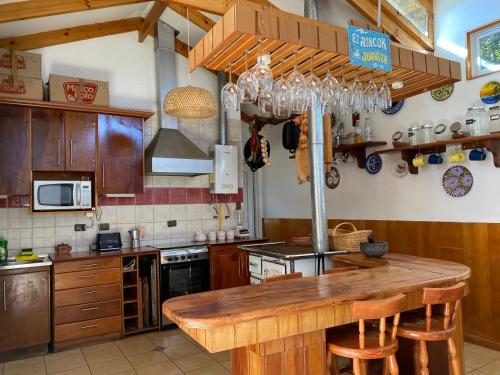 a kitchen with a wooden counter top in a kitchen at Gran casa en Isla Negra in Isla Negra