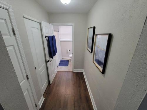 a hallway with two pictures on the walls of a house at Annapolis Escape Steps to Harbor backs to Gate 1 in Annapolis