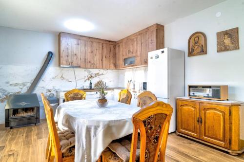 a kitchen with a table with chairs and a refrigerator at Pavle's Oasis in Virpazar