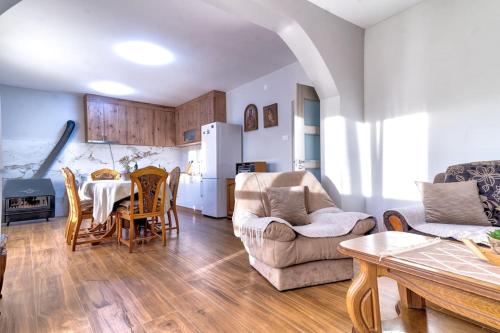 a kitchen and living room with a table and chairs at Pavle's Oasis in Virpazar