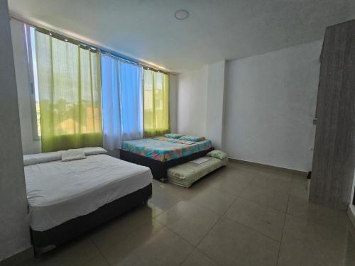 Postel nebo postele na pokoji v ubytování Brisa Marina Apartaestudios