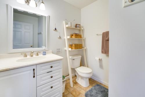 een badkamer met een toilet, een wastafel en een spiegel bij Lake Huron Vacation Rental with Private Beach! 