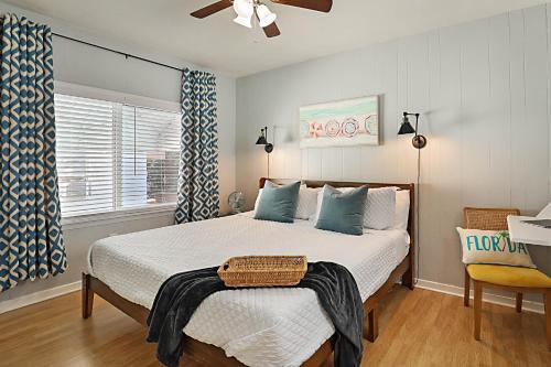 a bedroom with a bed and a ceiling fan at Steps to Beach & Downtown! Cozy Beach Bungalow #1 in Lake Worth
