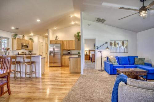 a living room with a blue couch and a kitchen at 28 Dragoon Ct in Pagosa Springs