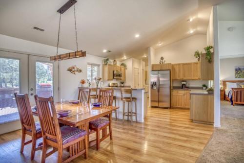 a kitchen and dining room with a wooden table and chairs at 28 Dragoon Ct in Pagosa Springs