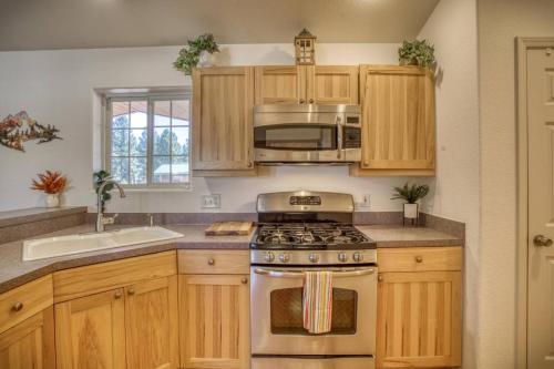 a kitchen with wooden cabinets and a stove top oven at 28 Dragoon Ct in Pagosa Springs