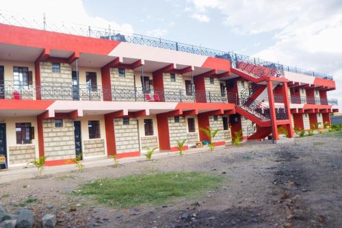 a building with red and white at Four Wheels Gardens Hotel & Accommodation in Kitengela 