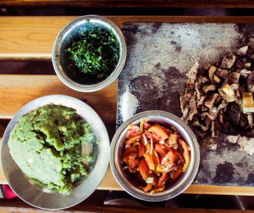 a table with three bowls of food on a tray at Four Wheels Gardens Hotel & Accommodation in Kitengela 