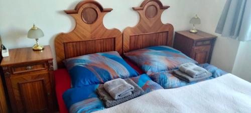 a bedroom with two beds with towels on them at Apartmány Maňová 