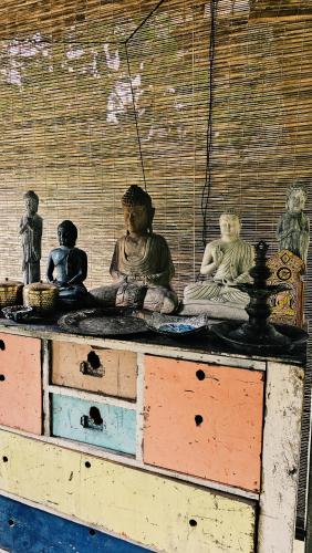 a bunch of statues sitting on top of a table at Jansen’s Bungalow Sinharaja Rainforest Retreat in Kudawe