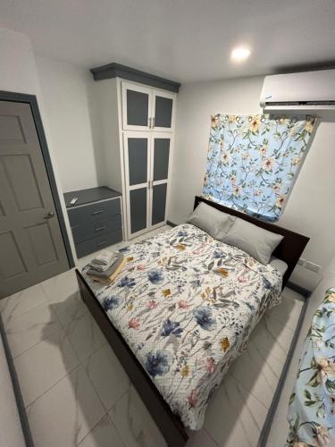 a bedroom with a bed with a floral bedspread at Enchanted Escapades in Vieux Fort