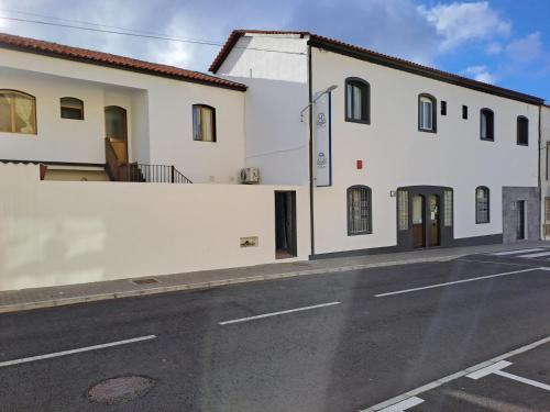 a white building on the side of a street at Hotel Ribeira Grande in Ribeira Grande