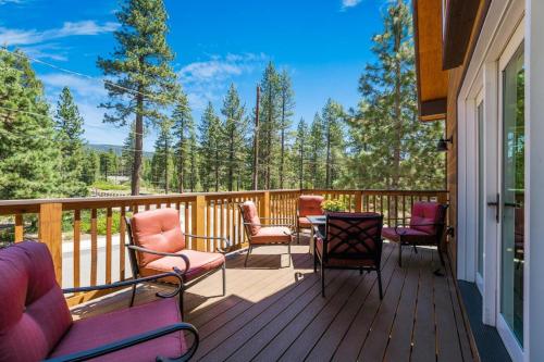 a deck with chairs and a table on a house at Agate Bay Gem by Tahoe Getaways - Charming Getaway with Cozy Fireplace Near Hiking and Biking Trails in Tahoe Vista