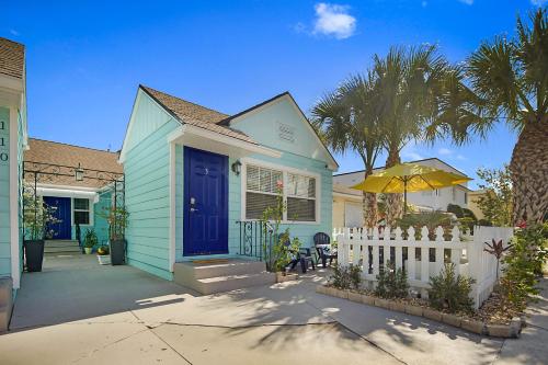 a blue house with a blue door and a white fence at Steps to Beach & Downtown! Cozy Beach Bungalow #3 in Lake Worth
