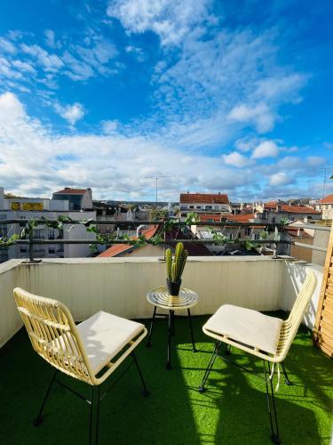 un patio avec deux chaises et une table sur un balcon dans l'établissement Nancy Gare - Studio Haut de gamme, à Nancy