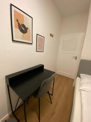 a black piano in a living room with a couch at Swan Rooms in Nürnberg