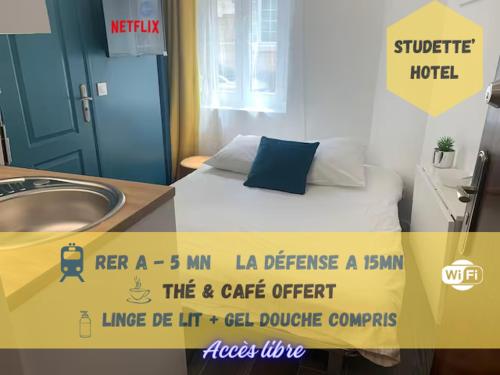 a room with a bed and a sink and a sign at Appart' Studette Cosy - STADE U ARENA in Maisons-Laffitte