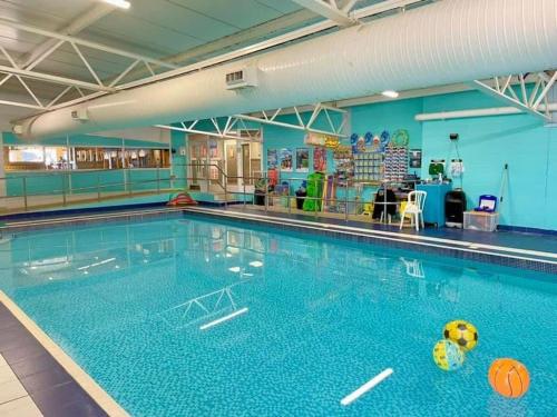 a swimming pool with a ball in the water at Cosy Cottage Caravan in Ashington