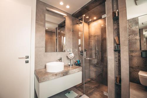 a bathroom with a sink and a shower at Lenneapartments Premium in Plettenberg